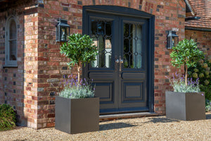 Large modern square Geo planters made in the UK from lightweight fibreglass in a grey faux lead finish.